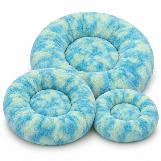 Set of three round blue and green plush pet beds in small, medium and large sizes.
